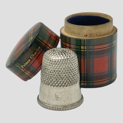 Main photo of the case seen with lid removed and leaning against the lower half of the case. The thimble is in the foreground with the 4/0 visible.